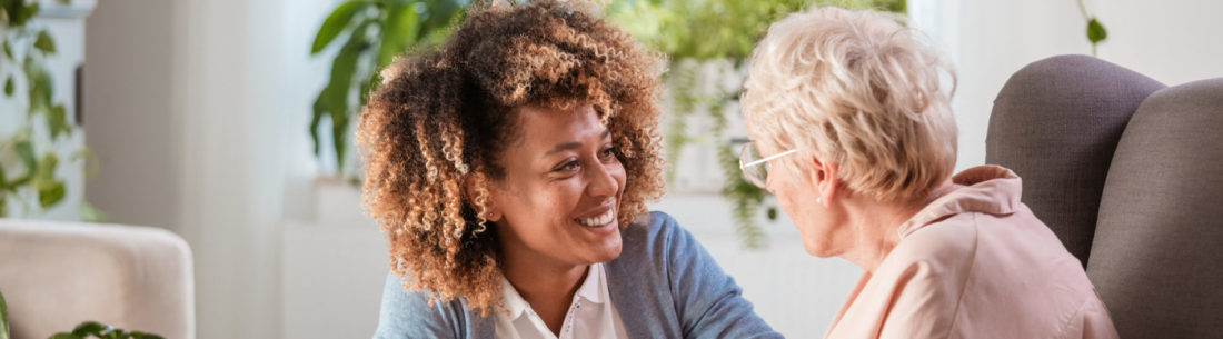 Friendly nurse supporting an eldery lady - Lagentium Insurance Brokers