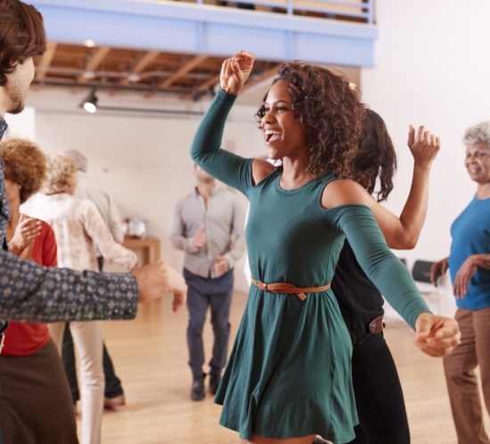 People Attending Dance Class In Community Center